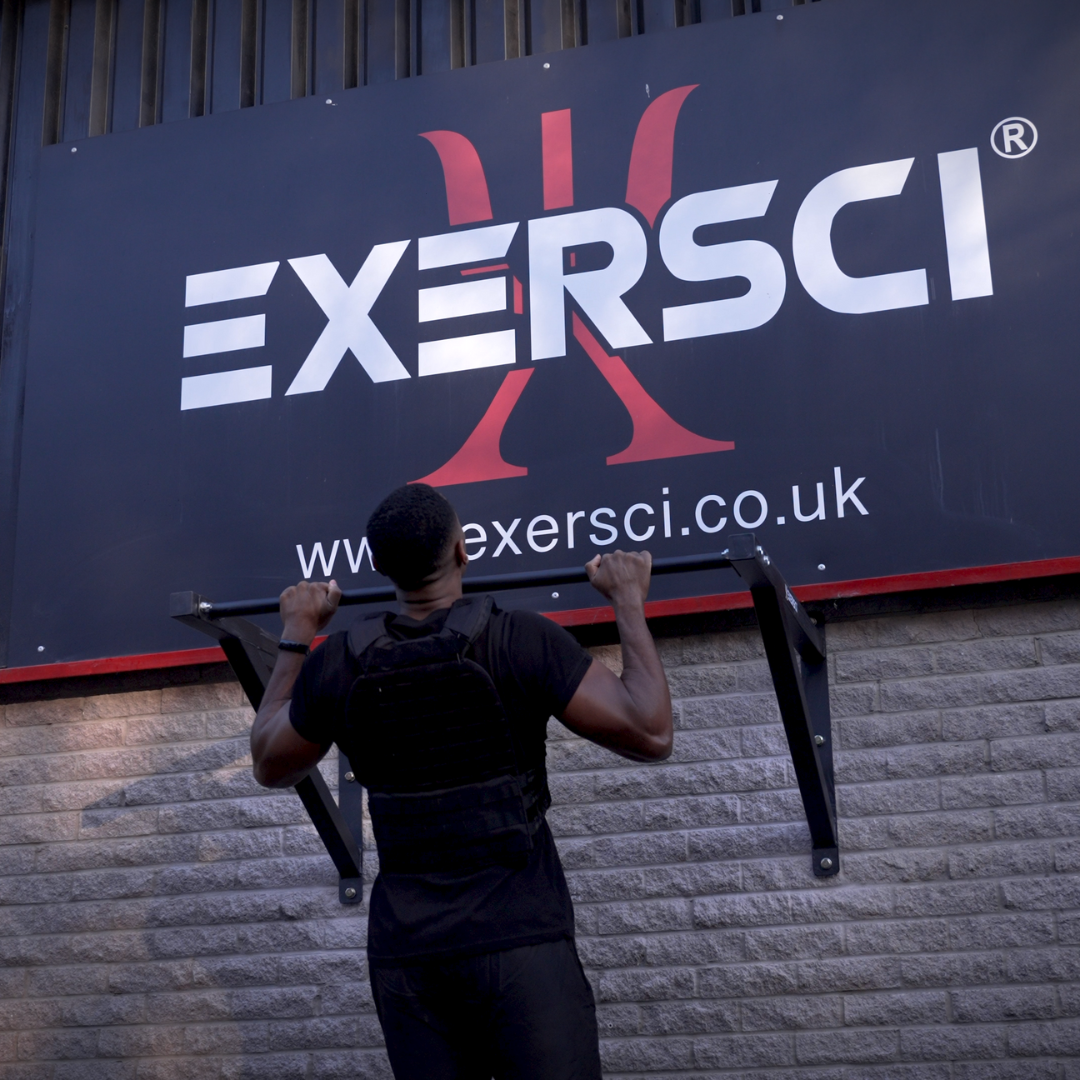 An image of a man performing a pull up on the Exersci heavy duty pull up bar in front of the Exersci sign to illustrate the blog entitled 'how to do pull-ups for beginners: The Perfect Form'
