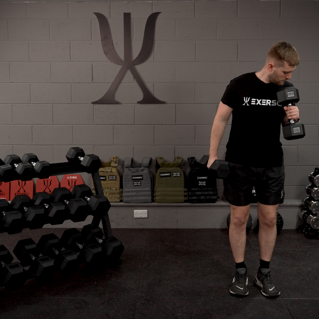 Image of a man performing a bicep curl with Exersci Hex Dumbbells in an Exersci branded gym to illustrate the Exersci blog post entitled 'How to Build a Compact Home Gym With Minimal Equipment?'