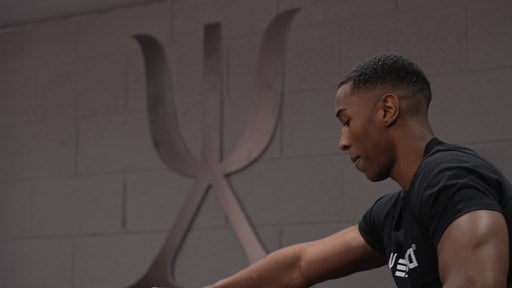 An image of a man exercising in front of the Exersci logo to illustrate the Exersci blog post 'Why Sports Science Professionals Recommend Exersci's Equipment'