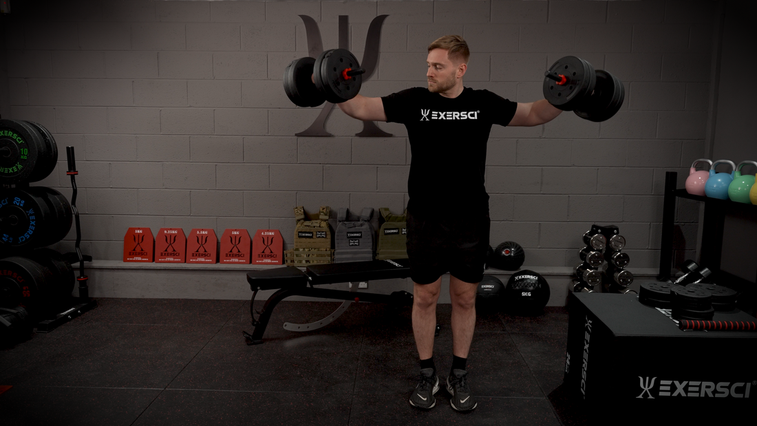 An image of a man performing lateral raises with the Exersci adjustable dumbbell, barbell, & kettlbell set to illustrate the Exersci blog post entitled 'Toning Muscle with Home Gym Equipment'