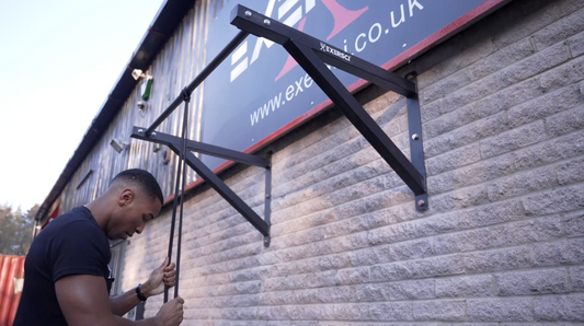 An image of a man using a resistance band for tricep extensions to illustrate the Exersci blog post entitled 'Stay Fit This Christmas: The Best Exersci Equipment for Holiday Workouts'