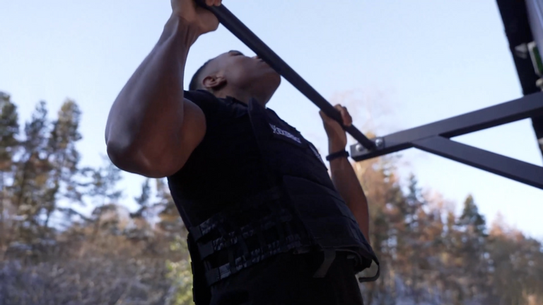 An image of a man performing pull-ups with the Exersci weighted vest, to illustrate the Exersci blog post entitled '10 beginner exercises for your new weighted vest'