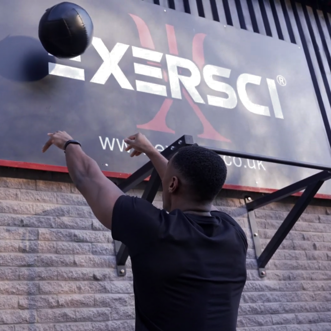 An image of a man performing wall ball throws to illustrate the Exersci blog post entitled 'Why You Should Priotise Strength Training - Even with a Busy Schedule'